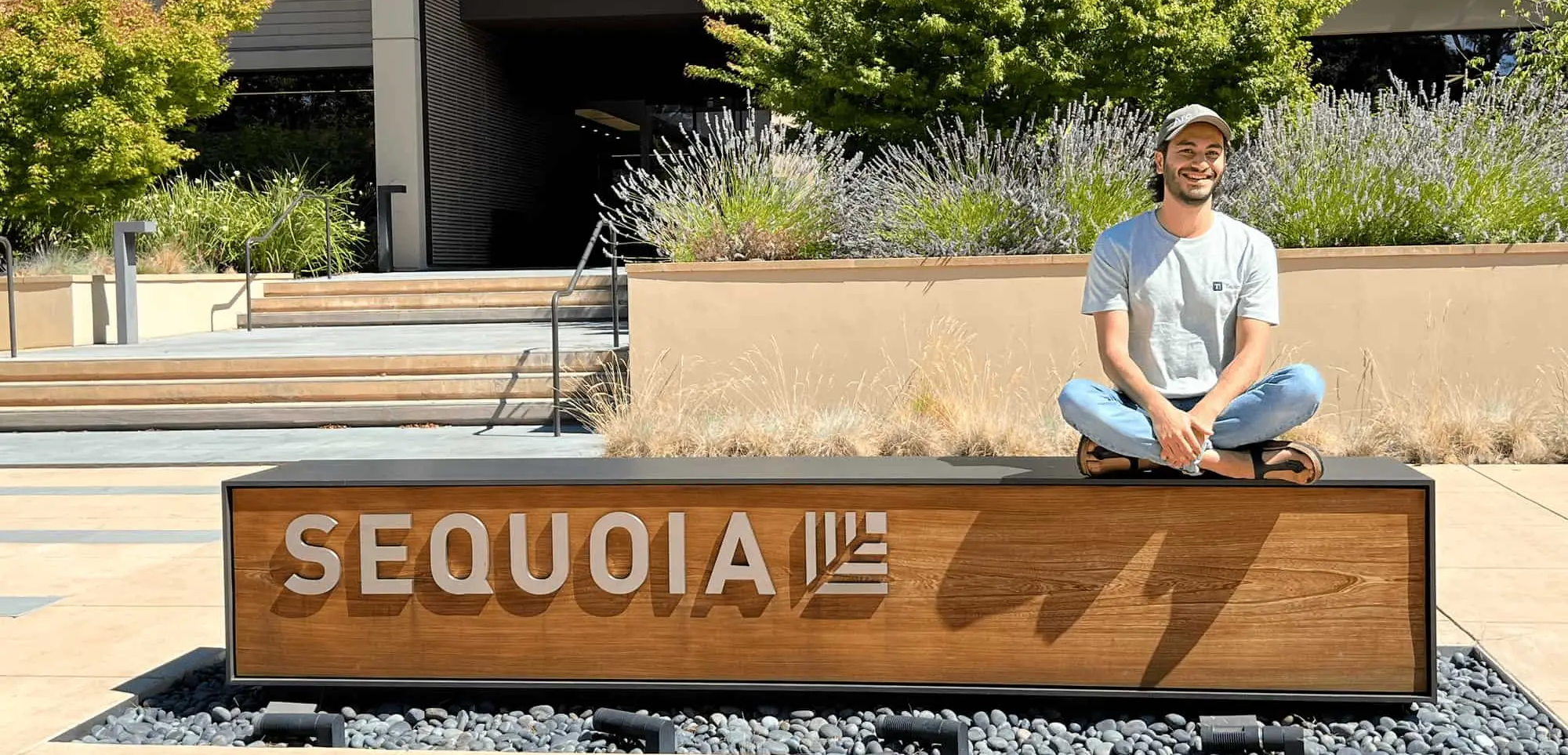 Man sitting on Sequoia sign